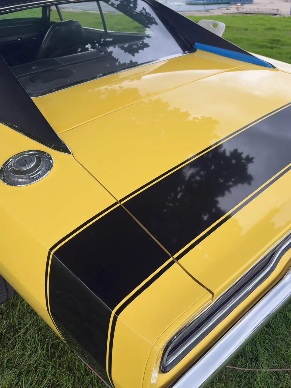 Glossy yellow paint and black stripe on a 1970 Dodge Charger after ceramic coating