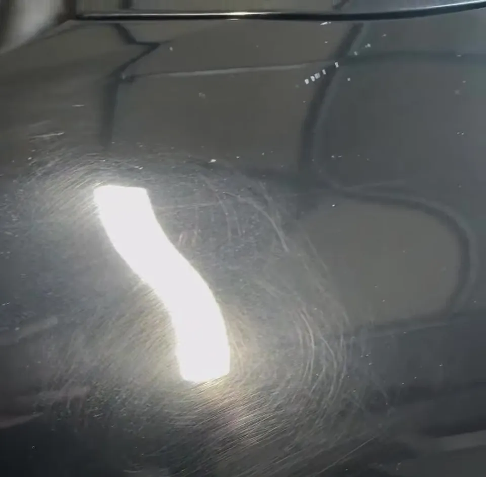 Before: heavy swirl marks and haze visible in the black paint of a Honda Crosstour under direct light